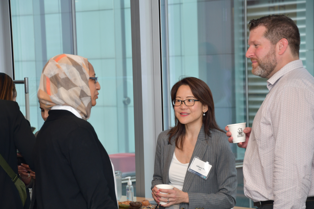 Nouar Elkhair, Juliana Wu, and Jordan hunt chatting over beverages at the partnership event.