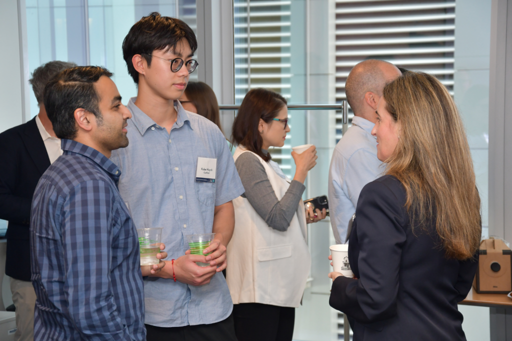 Sheraz Cheema, Kobe Huynh, and Victoria Kirsh chatting over beverages at the partnership event.