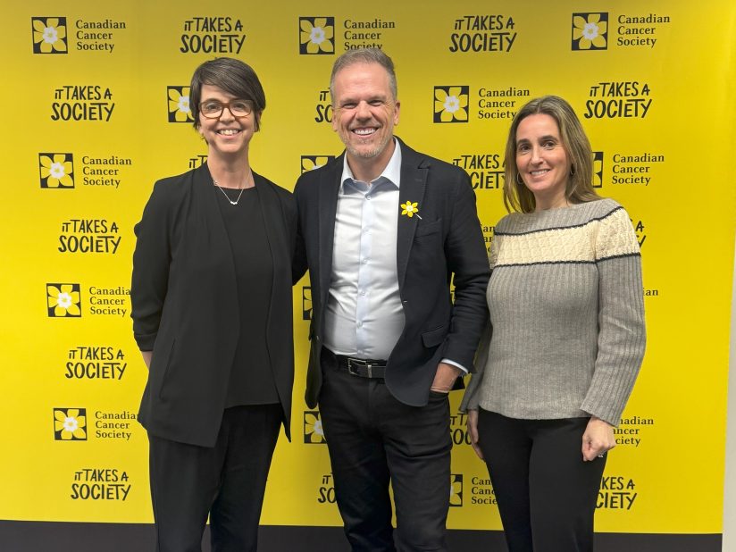 Jennifer Brooks, Mark Holland, and Victoria Kirsh in front of the Canadian Cancer Society banner.