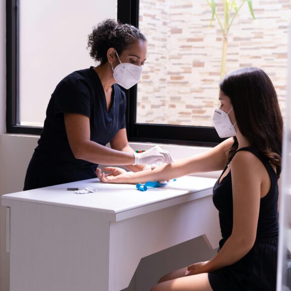 Nurse wiping the arm of a patient