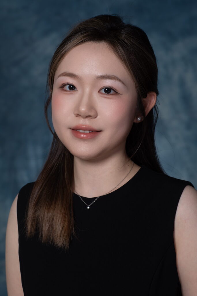 Portrait of Feifan Xiang smiling in a black tank top.